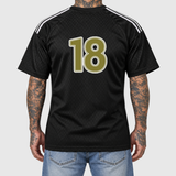 Gold Adidas football shirt model back mockup: original artwork composited onto an AI-generated tattooed model wearing blue jeans. Neutral light gray background.