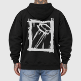 Splatter and Nail hoodie model back mockup: original artwork composited onto an AI-generated tattooed model wearing blue jeans. Neutral light gray background.