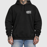 Splatter and Nail hoodie model front mockup: original artwork composited onto an AI-generated tattooed model wearing blue jeans. Neutral light gray background.