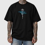 UTIRO Syringe shirt front, original artwork composited onto an AI-generated model wearing blue jeans. Neutral light gray background.