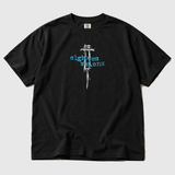 UTIRO Syringe front product mockup: original artwork composited onto a realistic black Comfort Colors shirt flatlay. Neutral light gray background.